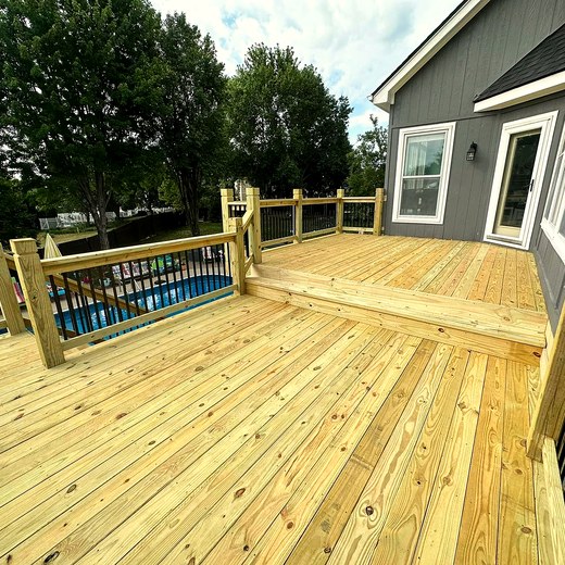 Wide new deck boards running alongside a pool.