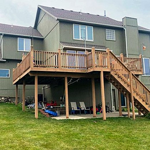 Two-story deck with stairs and a patio underneath.