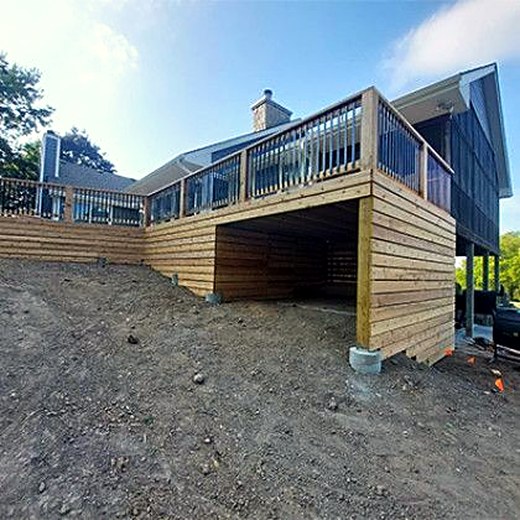 Elevated deck with a screened upper level and open framing below.