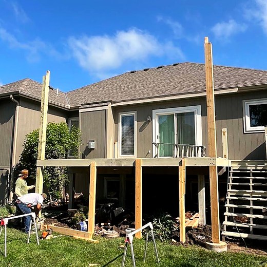 Screened porch under construction with the posts set and the deck framed.