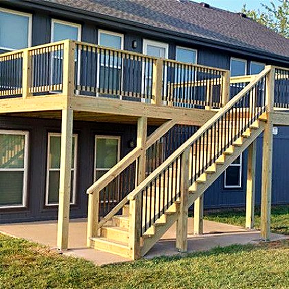 Two-story deck with stairs on a blue-grey house.