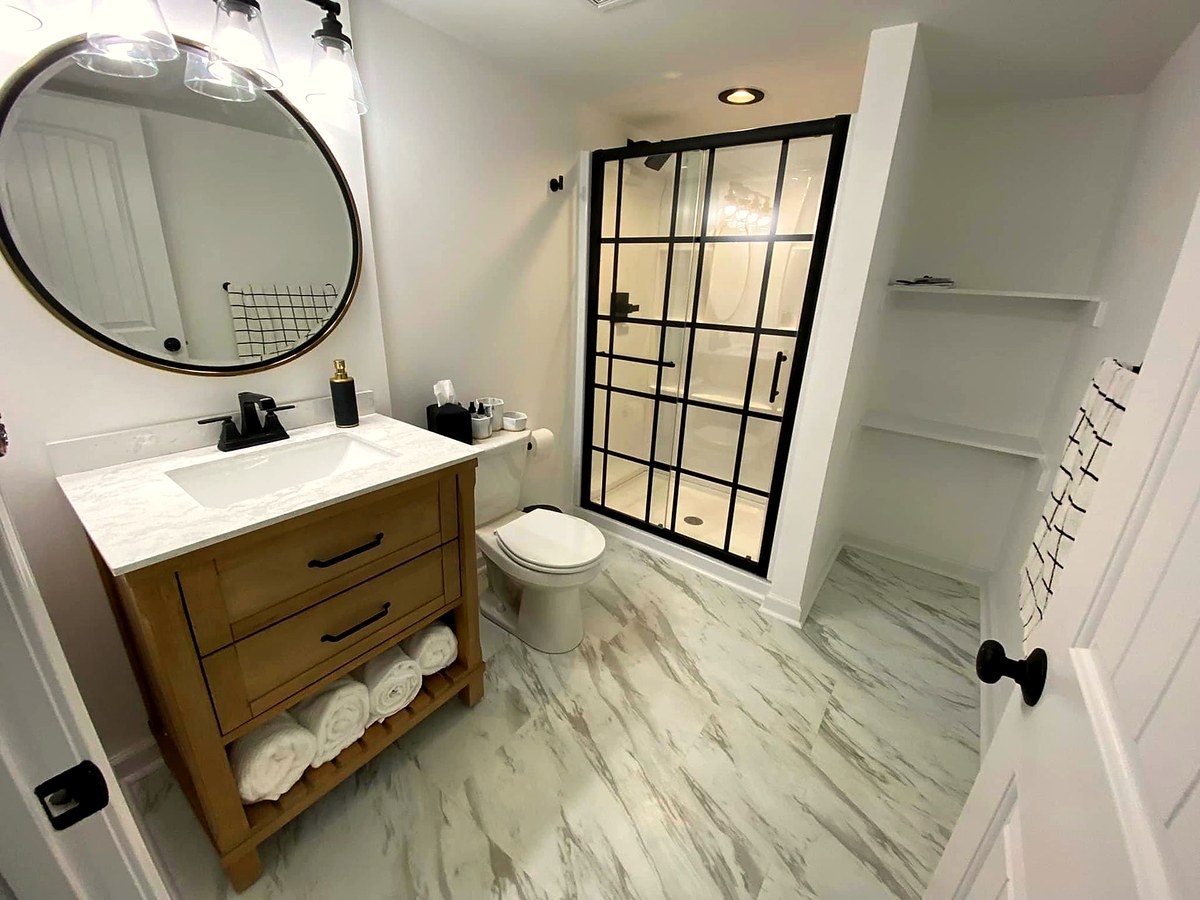 Finished lower-level bathroom with a glass shower and vanity.