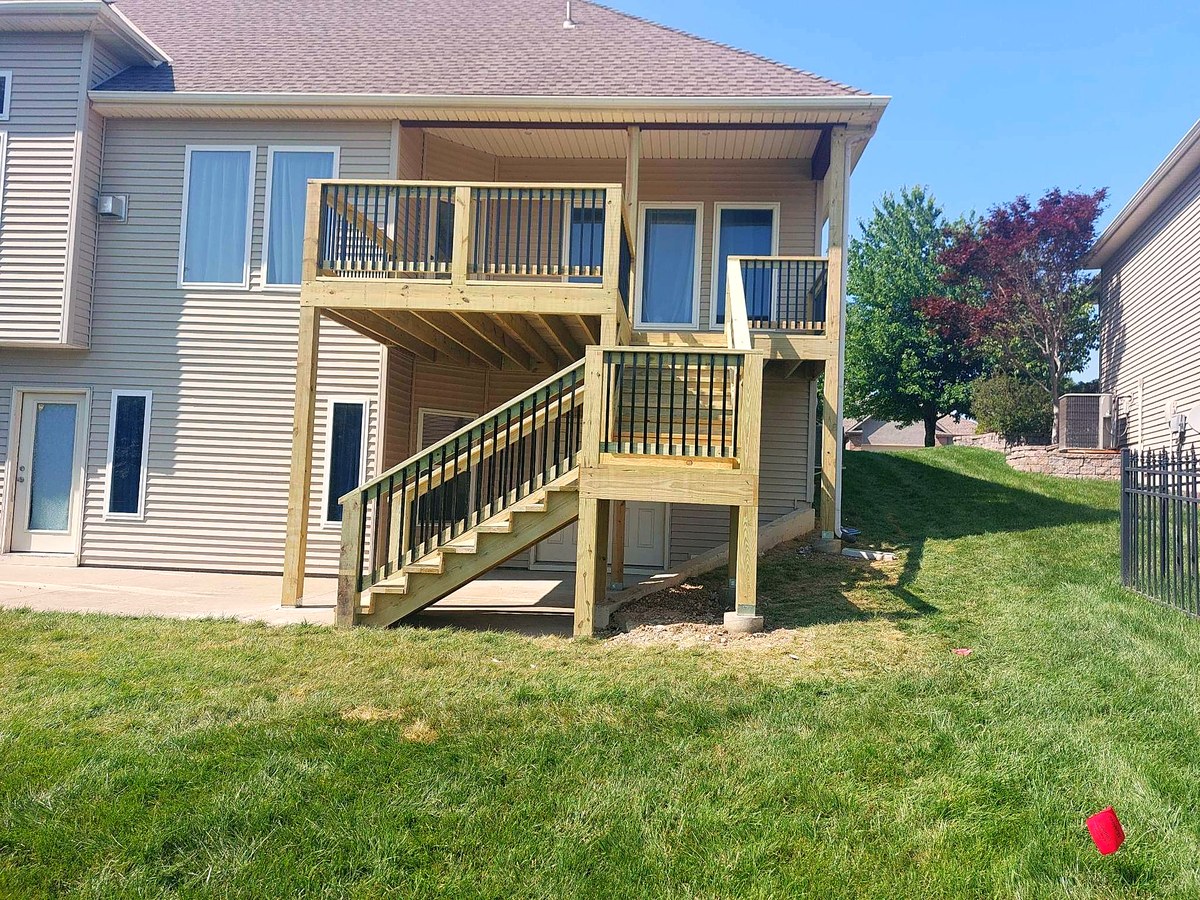 Two-story deck with a stair run on the back of a suburban home.
